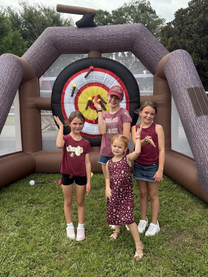 Kids at the inflatable tomahawk toss
